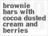recipe for brownie bars with cocoa dusted cream and berries