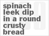 recipe for spinach-leek dip in a round crusty bread